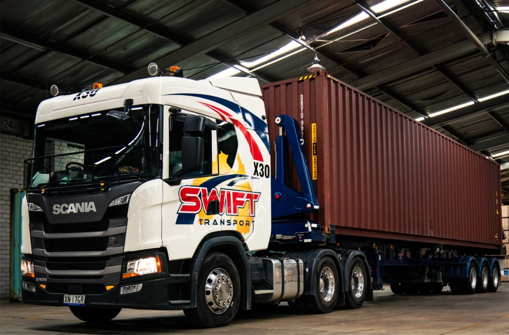 Swift Transport branded Scania truck carrying a shipping container, a source photograph used in the website redesign